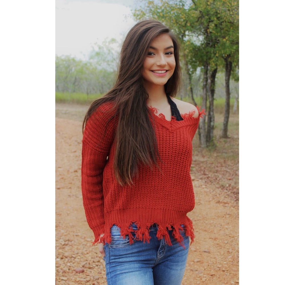 Distressed fringe sweater.